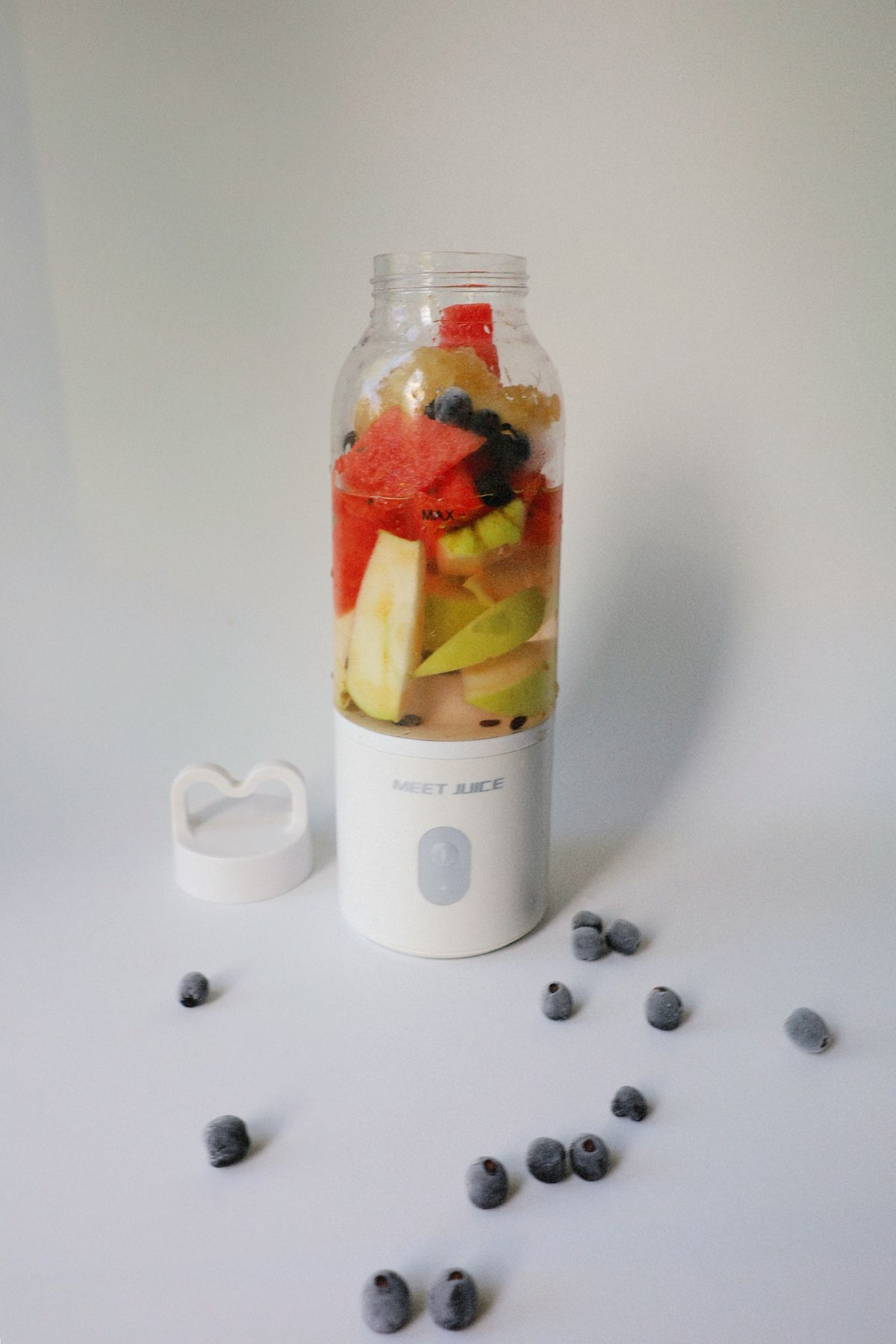 Portable blender with fresh fruit and blueberries