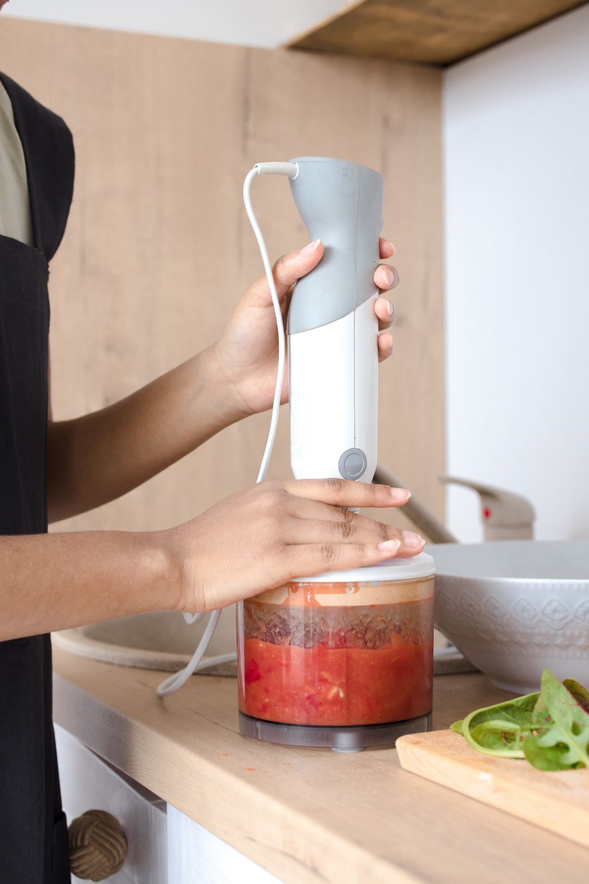 Using an immersion hand blender directly in a pot to blend soup